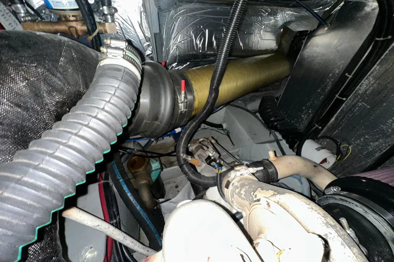 Slide: The Image of Engine room of 1998 Carver 445 Aft Cabin Motor Yacht, showing hoses and mechanical components. - 99