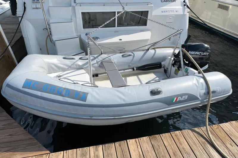 Slide: The Image of 1998 Carver 445 Aft Cabin Motor Yacht docked at marina under cloudy sky. - 10