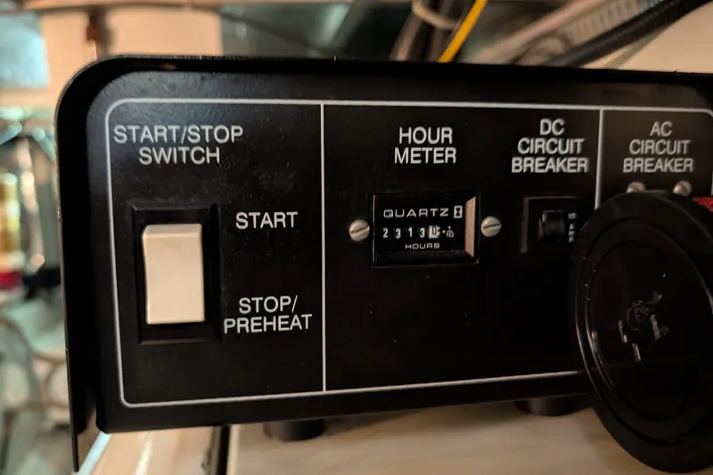 Slide: The Image of Control panel of a 1998 Carver 445 Aft Cabin Motor Yacht with hour meter and switches. - 103