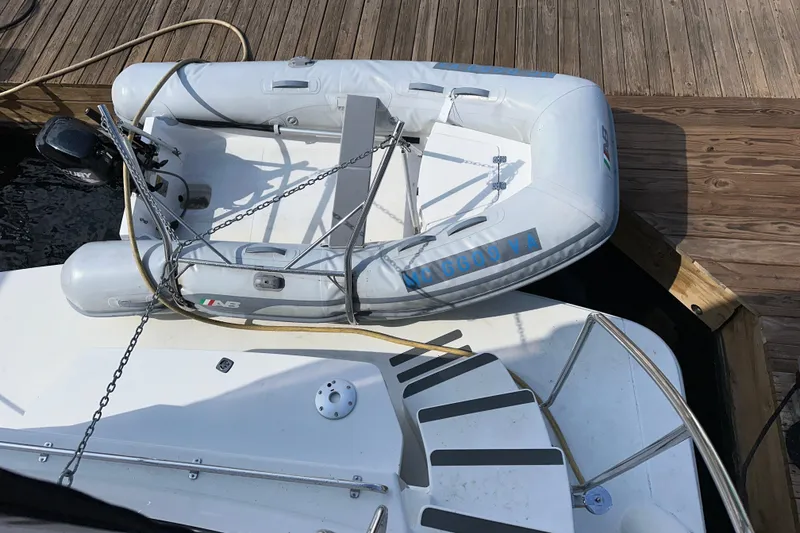 Slide: The Image of 1998 Carver 445 Aft Cabin Motor Yacht docked at marina under cloudy sky. - 12