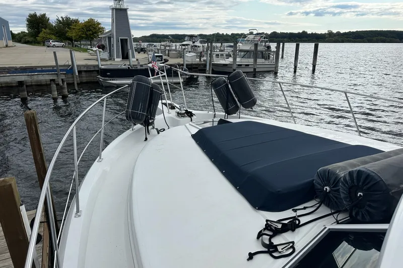 Slide: The Image of 1998 Carver 445 Aft Cabin Motor Yacht docked under cloudy skies. - 13