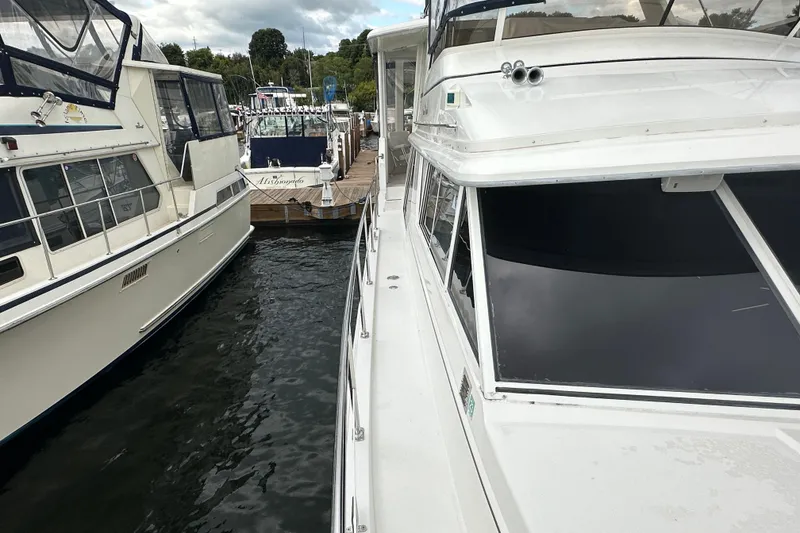 Slide: The Image of 1998 Carver 445 Aft Cabin Motor Yacht docked with inflatable boat attached. - 19