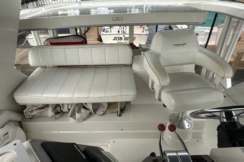 Slide: The Image of 1998 Carver 445 Aft Cabin Motor Yacht docked alongside other boats at a marina. - 28