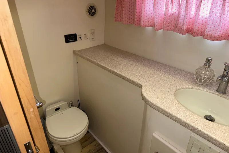 Slide: The Image of 1998 Carver 445 Aft Cabin Motor Yacht with outdoor seating and marina view. - 55