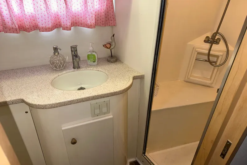 Slide: The Image of 1998 Carver 445 Aft Cabin Motor Yacht interior with seating and storage, docked at marina. - 56