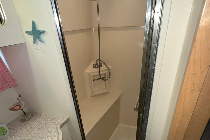 Slide: The Image of 1998 Carver 445 Aft Cabin Motor Yacht interior with seating, stairs, and storage. - 57