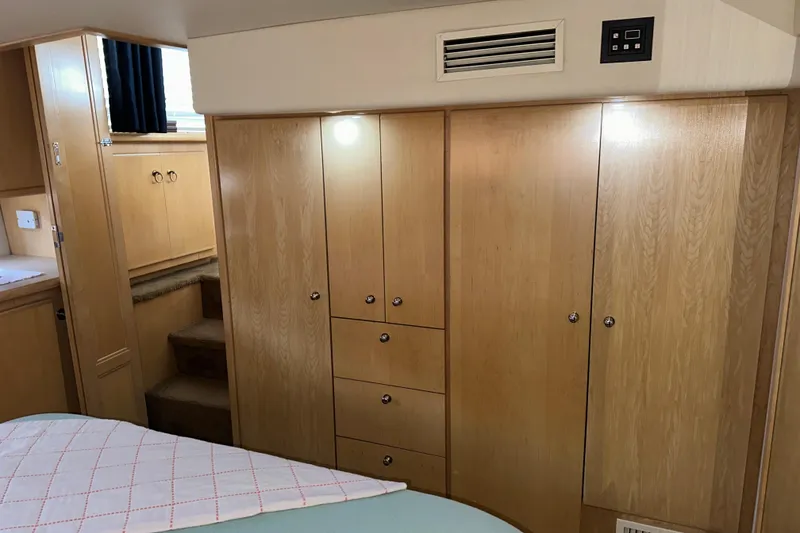 Slide: The Image of 1998 Carver 445 Aft Cabin Motor Yacht interior with seating and kitchenette area. - 58