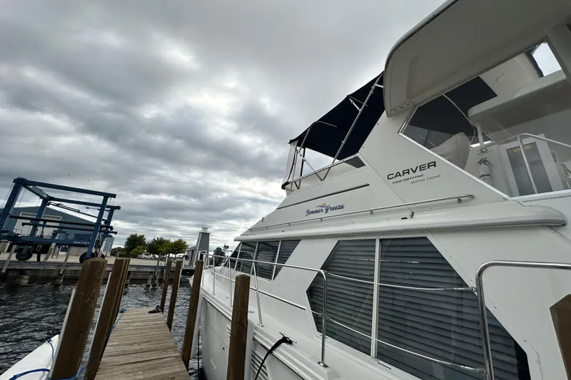 Slide: The Image of 1998 Carver 445 Aft Cabin Motor Yacht docked on a sunny day. - 6
