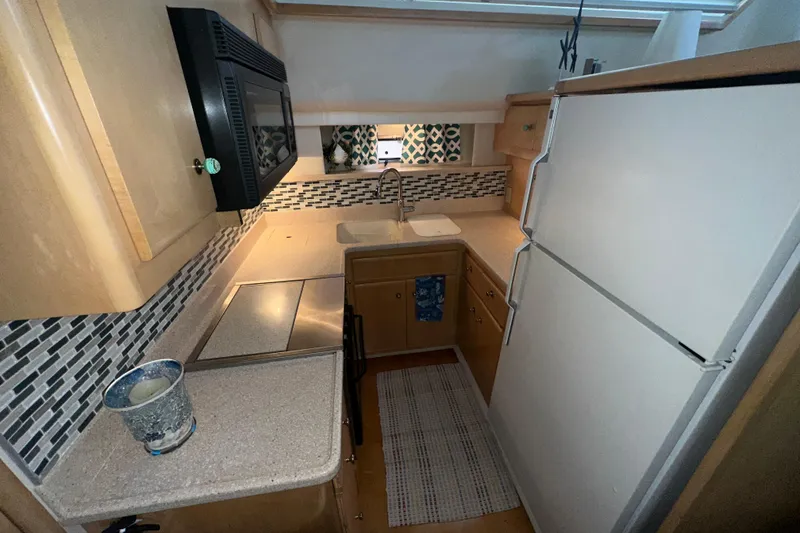 Slide: The Image of Luxurious interior of 1998 Carver 445 Aft Cabin Motor Yacht with beige leather sofa. - 71