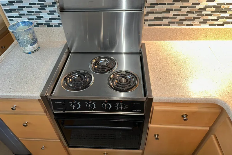 Slide: The Image of Interior of 1998 Carver 445 Aft Cabin Motor Yacht with plush armchair and wooden cabinetry. - 72