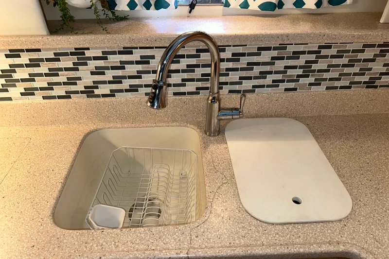 Slide: The Image of Interior of 1998 Carver 445 Aft Cabin Motor Yacht with beige leather sofa and blue accents. - 73