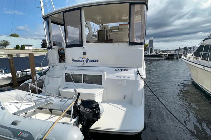 Slide: The Image of 1998 Carver 445 Aft Cabin Motor Yacht docked under sunny skies. - 8