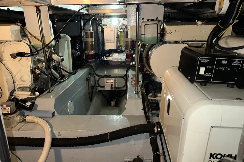 Slide: The Image of 1998 Carver 445 Aft Cabin Motor Yacht interior with beige leather seating and table. - 81