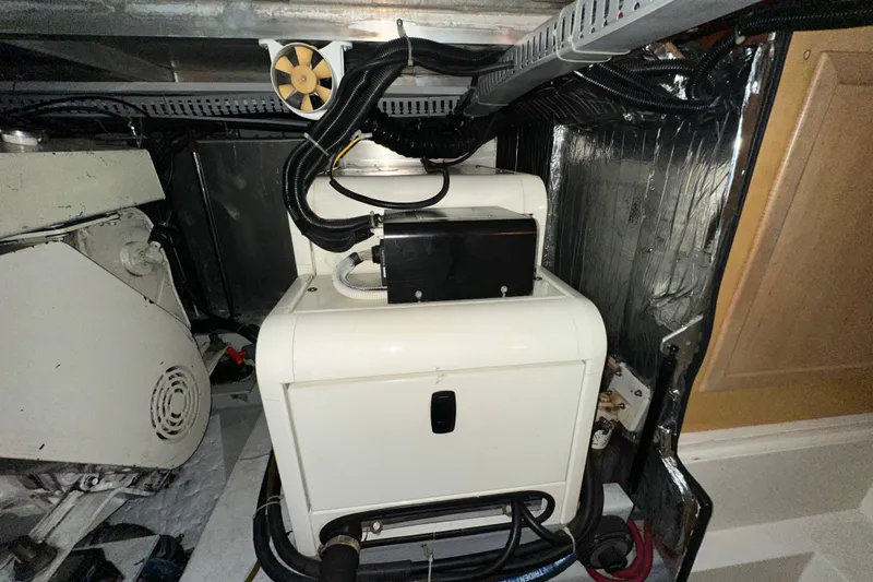 Slide: The Image of 1998 Carver 445 Aft Cabin Motor Yacht interior with cozy bedroom and wooden furnishings. - 86