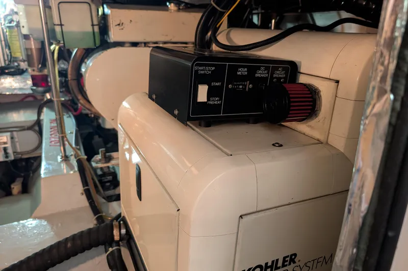 Slide: The Image of 1998 Carver 445 Aft Cabin Motor Yacht interior, showing engine access hatch and seating area. - 91