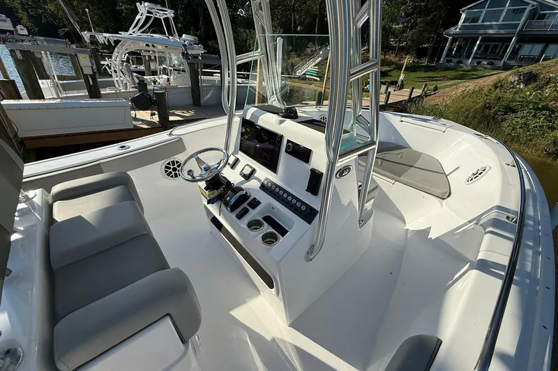 Slide: The Image of 2025 Cape Horn 22 OS boat interior with steering console and seating. - 12