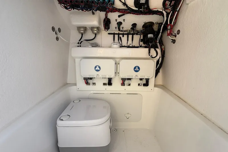 Slide: The Image of 2025 Cape Horn 22 OS boat interior with wiring and portable toilet. - 14