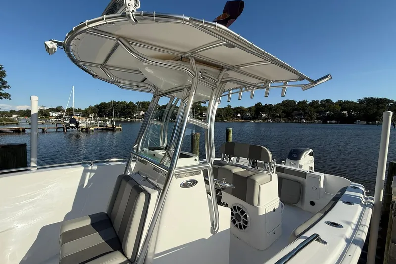 Slide: The Image of 2025 Cape Horn 22 OS boat with T-top, docked by a scenic waterfront. - 21
