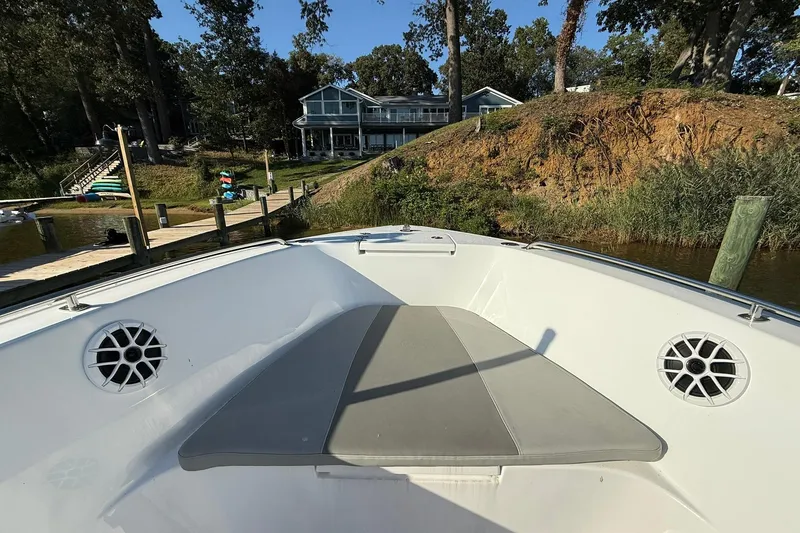Slide: The Image of 2025 Cape Horn 22 OS boat interior with speakers, dock, and waterfront house view. - 4