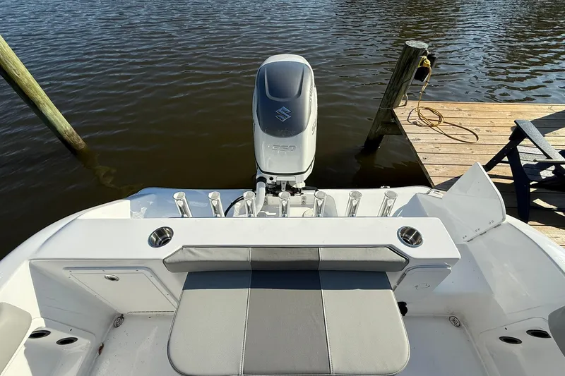 Slide: The Image of 2025 Cape Horn 22 OS boat with Suzuki engine docked by wooden pier. - 13