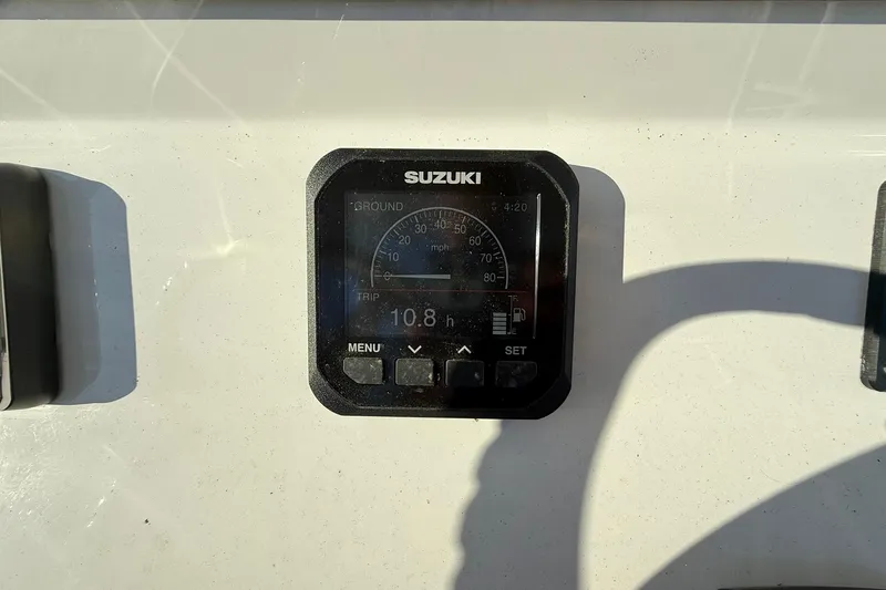 Slide: The Image of Suzuki gauge on 2025 Cape Horn 22 OS boat dashboard, displaying trip data. - 22
