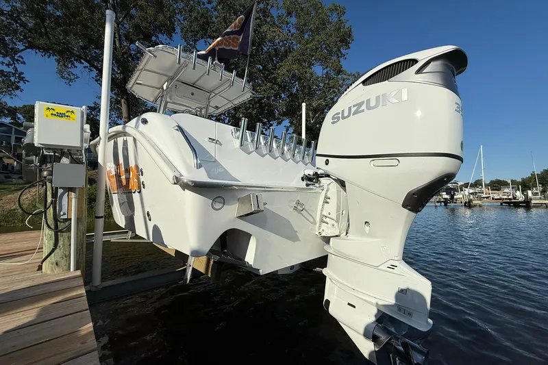 Slide: The Image of 2025 Cape Horn 22 OS boat with Suzuki engine docked by the water. - 3