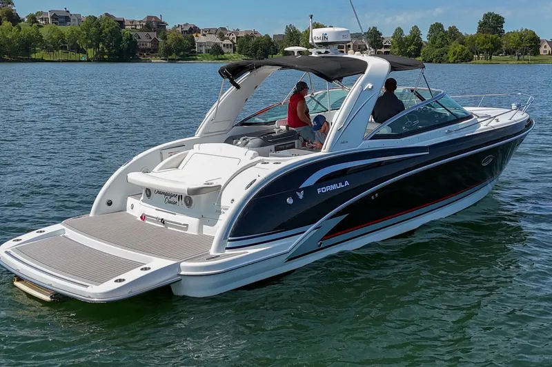 Slide: The Image of 2014 Formula 350 Sun Sport boat cruising on a scenic lake. - 12