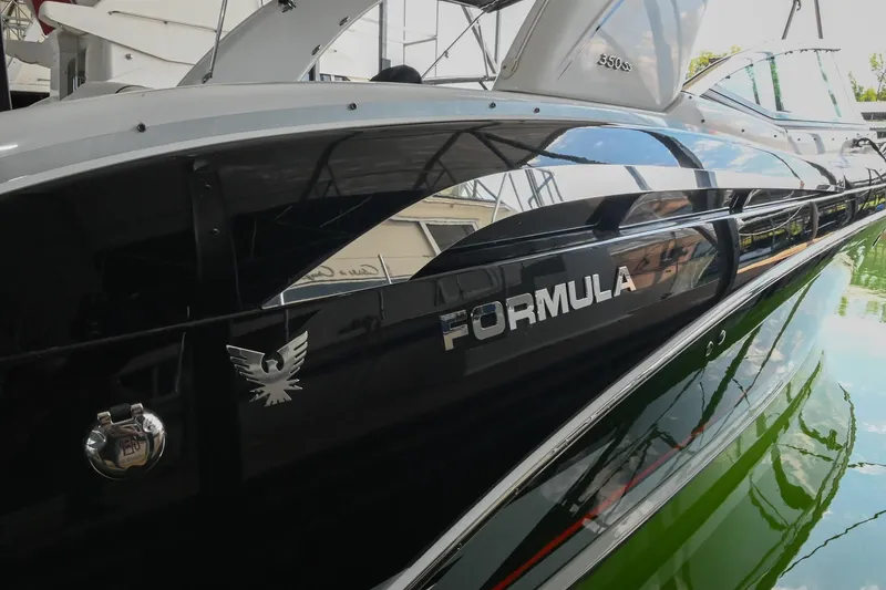Slide: The Image of 2014 Formula 350 Sun Sport boat with sleek black exterior and reflective finish. - 14
