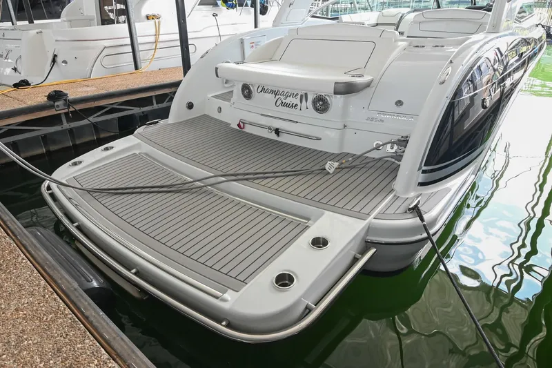 Slide: The Image of 2014 Formula 350 Sun Sport boat docked, featuring spacious swim platform and sleek design. - 17