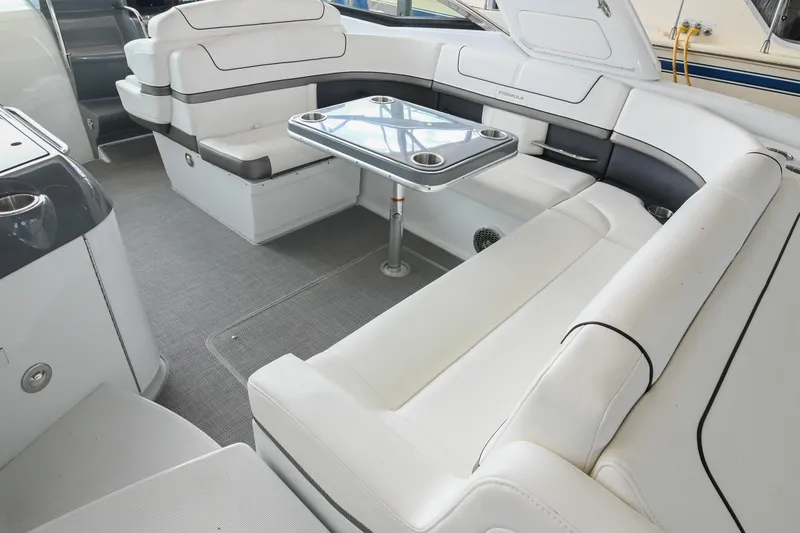 Slide: The Image of 2014 Formula 350 Sun Sport interior with white seating and a sleek glass table. - 21
