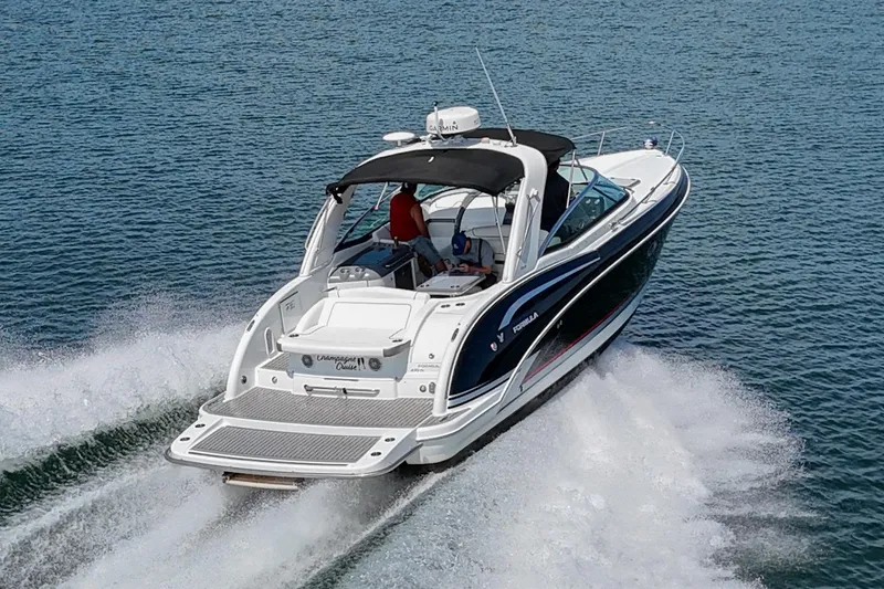 Slide: The Image of 2014 Formula 350 Sun Sport boat cruising on open water. - 3