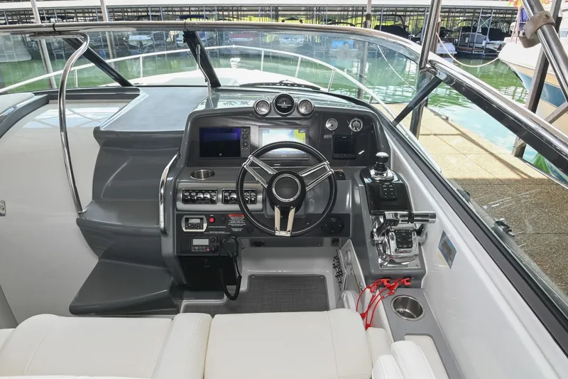 Slide: The Image of 2014 Formula 350 Sun Sport boat cockpit with modern controls and steering wheel. - 35