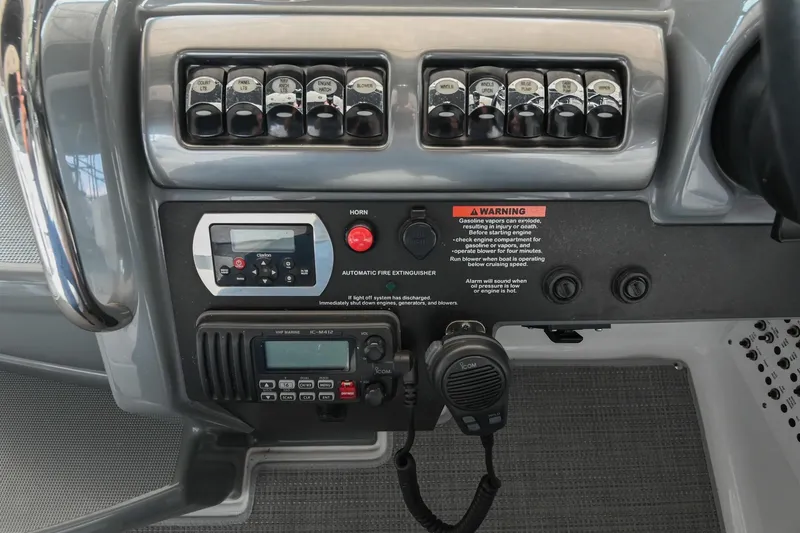 Slide: The Image of Control panel of a 2014 Formula 350 Sun Sport boat with switches and radio. - 37