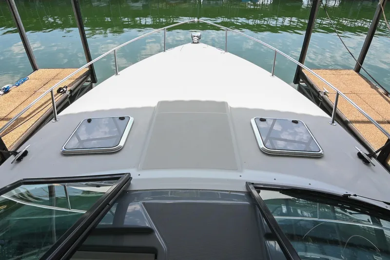 Slide: The Image of 2014 Formula 350 Sun Sport boat deck with hatches, docked on calm water. - 42