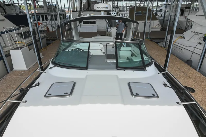 Slide: The Image of 2014 Formula 350 Sun Sport boat docked in a marina, featuring a sleek design. - 44