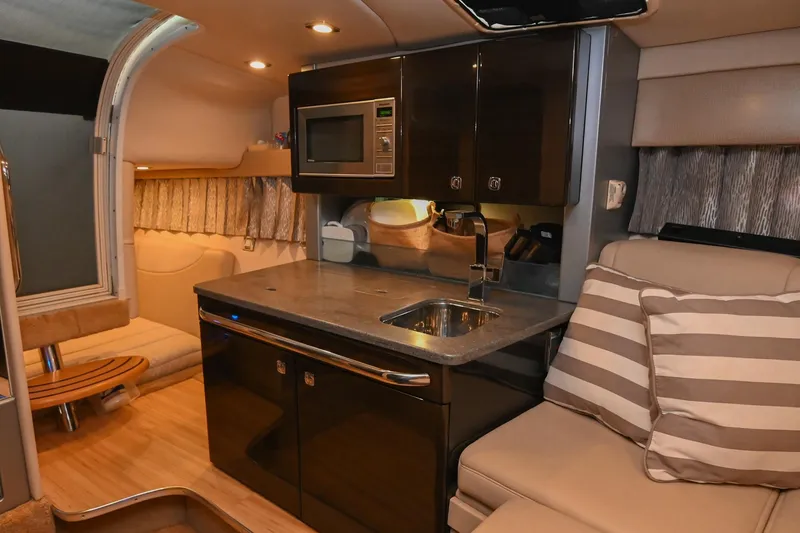 Slide: The Image of 2014 Formula 350 Sun Sport interior with kitchenette, microwave, and seating area. - 49