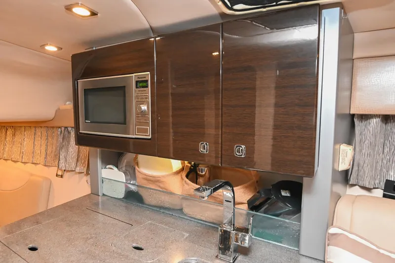Slide: The Image of 2014 Formula 350 Sun Sport interior kitchen with microwave and sleek cabinetry. - 52