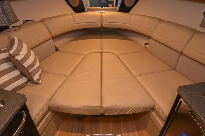 Slide: The Image of 2014 Formula 350 Sun Sport interior with beige leather seating and striped pillow. - 56