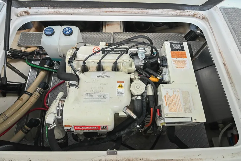 Slide: The Image of Engine compartment of a 2014 Formula 350 Sun Sport boat, featuring mechanical components and wiring. - 73