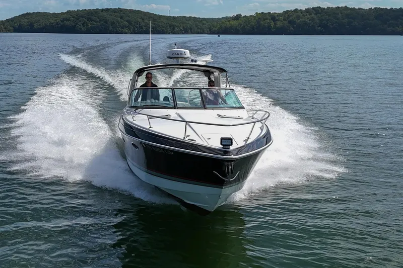 Slide: The Image of 2014 Formula 350 Sun Sport cruising on a scenic lake with lush green hills. - 78