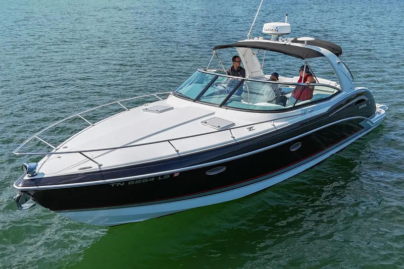 Slide: The Image of 2014 Formula 350 Sun Sport boat cruising on calm water with passengers onboard. - 9