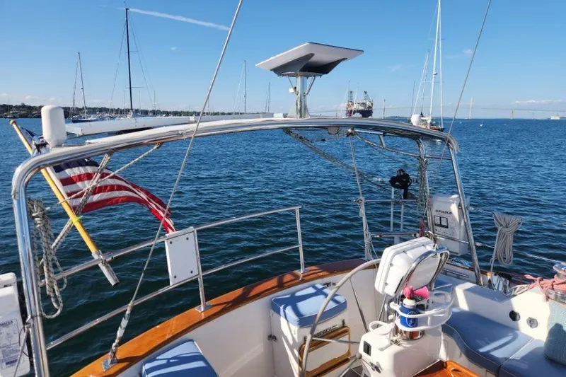 Slide: The Image of 2008 Bruckmann 50 MKII yacht on calm waters with American flag and clear sky. - 17