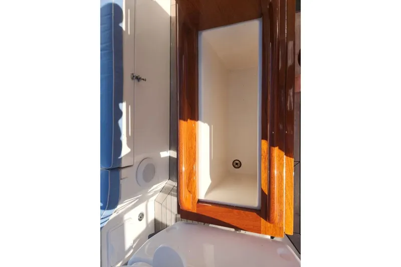 Slide: The Image of Interior view of a 2008 Bruckmann 50 MKII yacht, featuring wooden cabinetry and seating. - 19