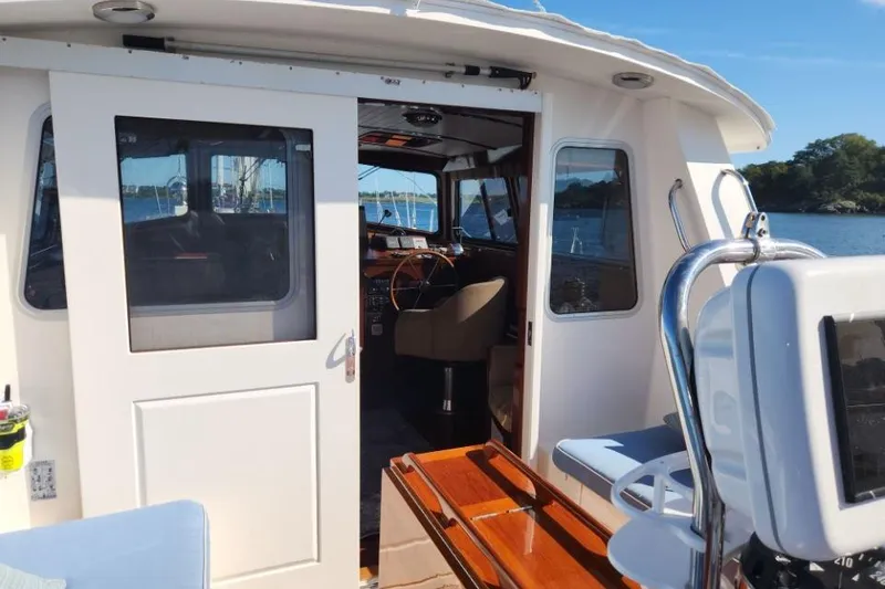 Slide: The Image of 2008 Bruckmann 50 MKII yacht interior with open cabin door, steering wheel visible. - 20