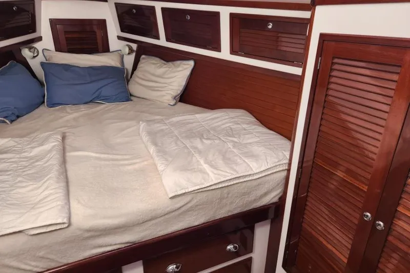 Slide: The Image of Cozy cabin interior of 2008 Bruckmann 50 MKII with wooden accents and bedding. - 24