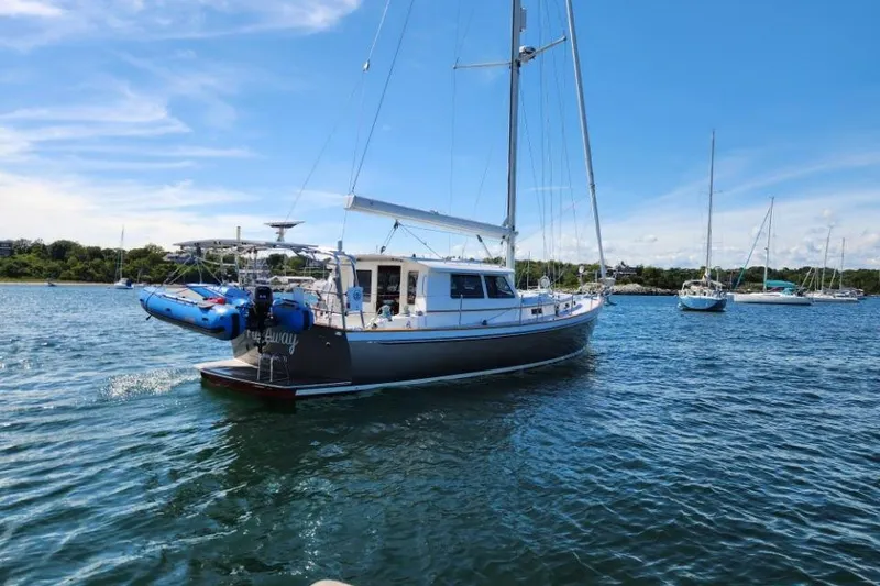 Slide: The Image of Sailing yacht Bruckmann 50 MKII, 2008 model, anchored in a serene bay under clear skies. - 3