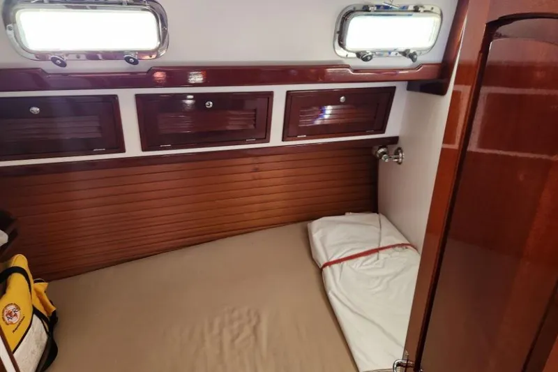 Slide: The Image of Cozy cabin interior of 2008 Bruckmann 50 MKII yacht with wooden finish and storage. - 30