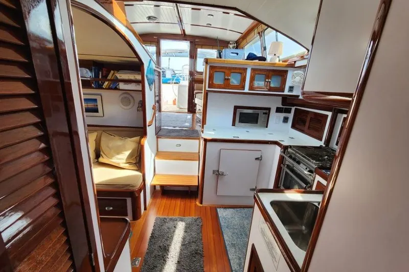 Slide: The Image of Luxurious 2008 Bruckmann 50 MKII yacht interior with wood finishes and modern kitchen amenities. - 34