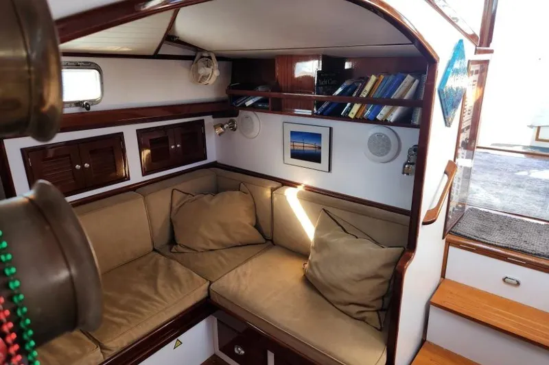 Slide: The Image of Cozy interior of 2008 Bruckmann 50 MKII yacht with cushioned seating and bookshelves. - 37