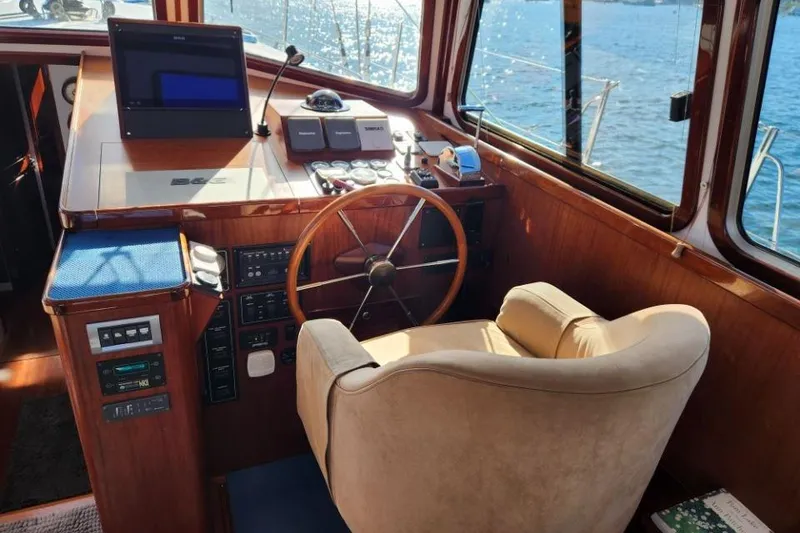 Slide: The Image of Helm of 2008 Bruckmann 50 MKII yacht with wooden finish and navigation equipment. - 44